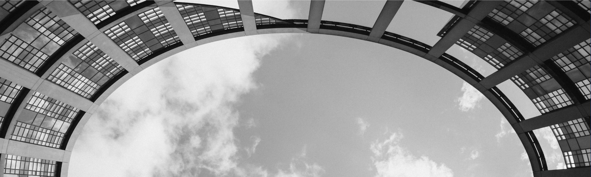 worm's view black and white photo of building and sky 