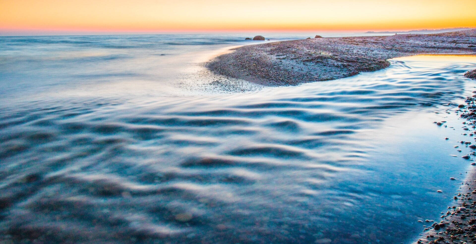 closeup of calm water with sunset