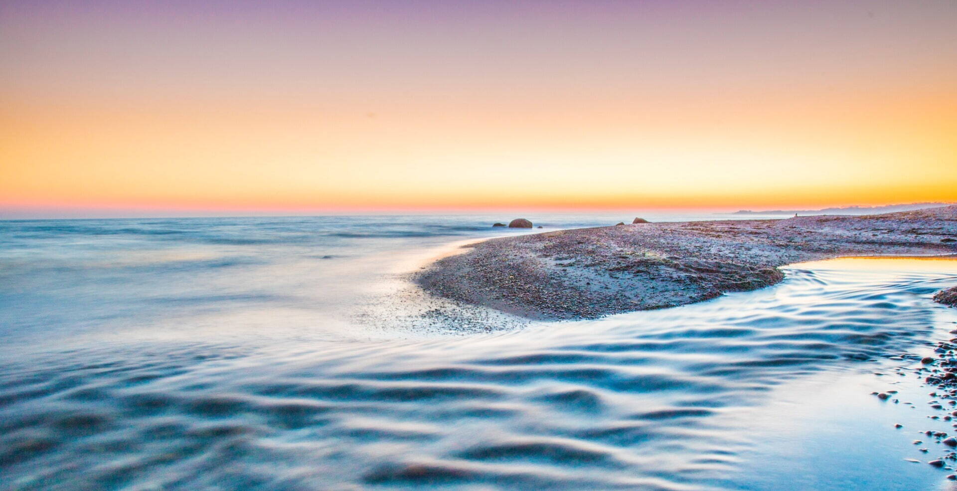 pastel sunset with calm sea and beach