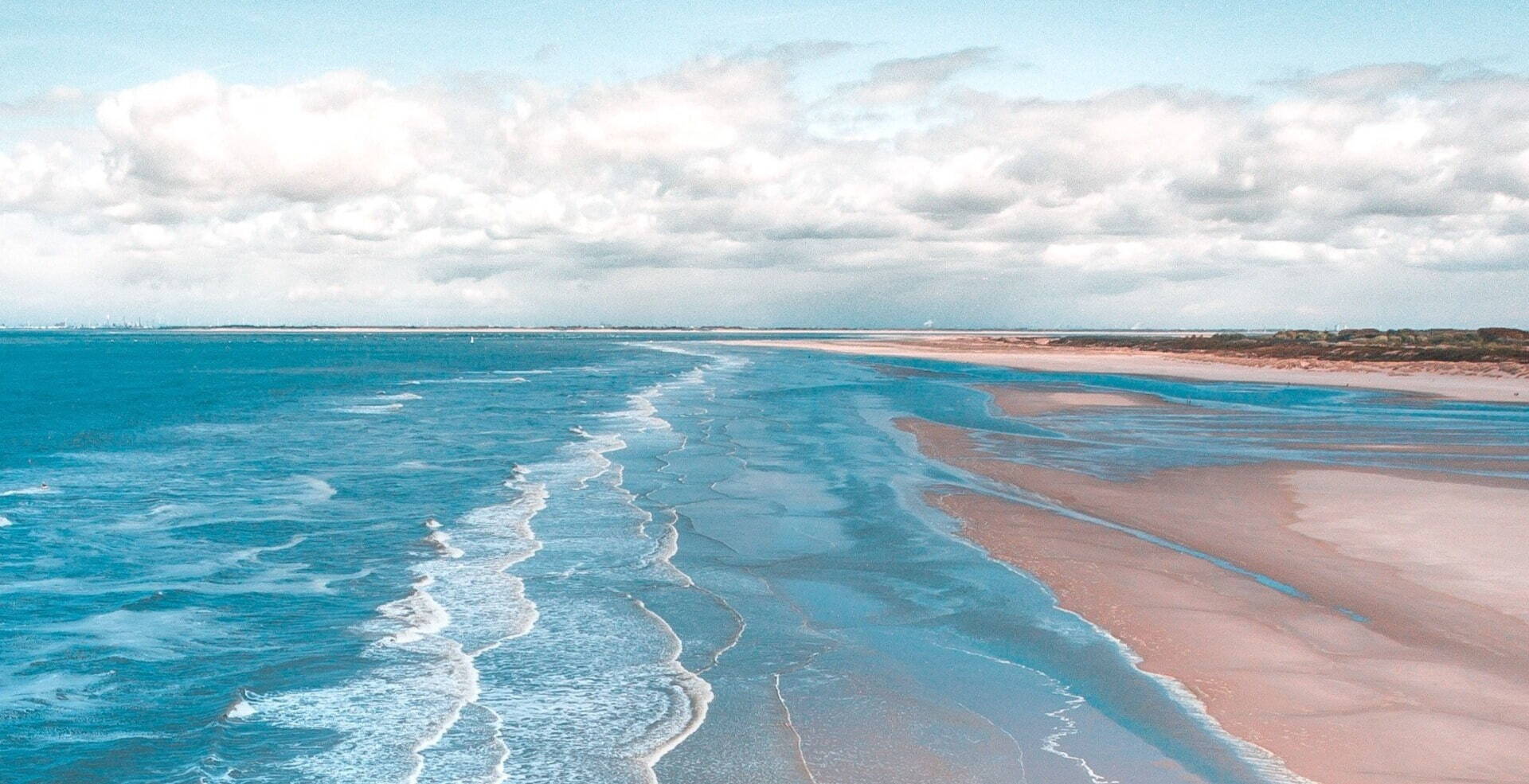 pink beach with turquoise waves