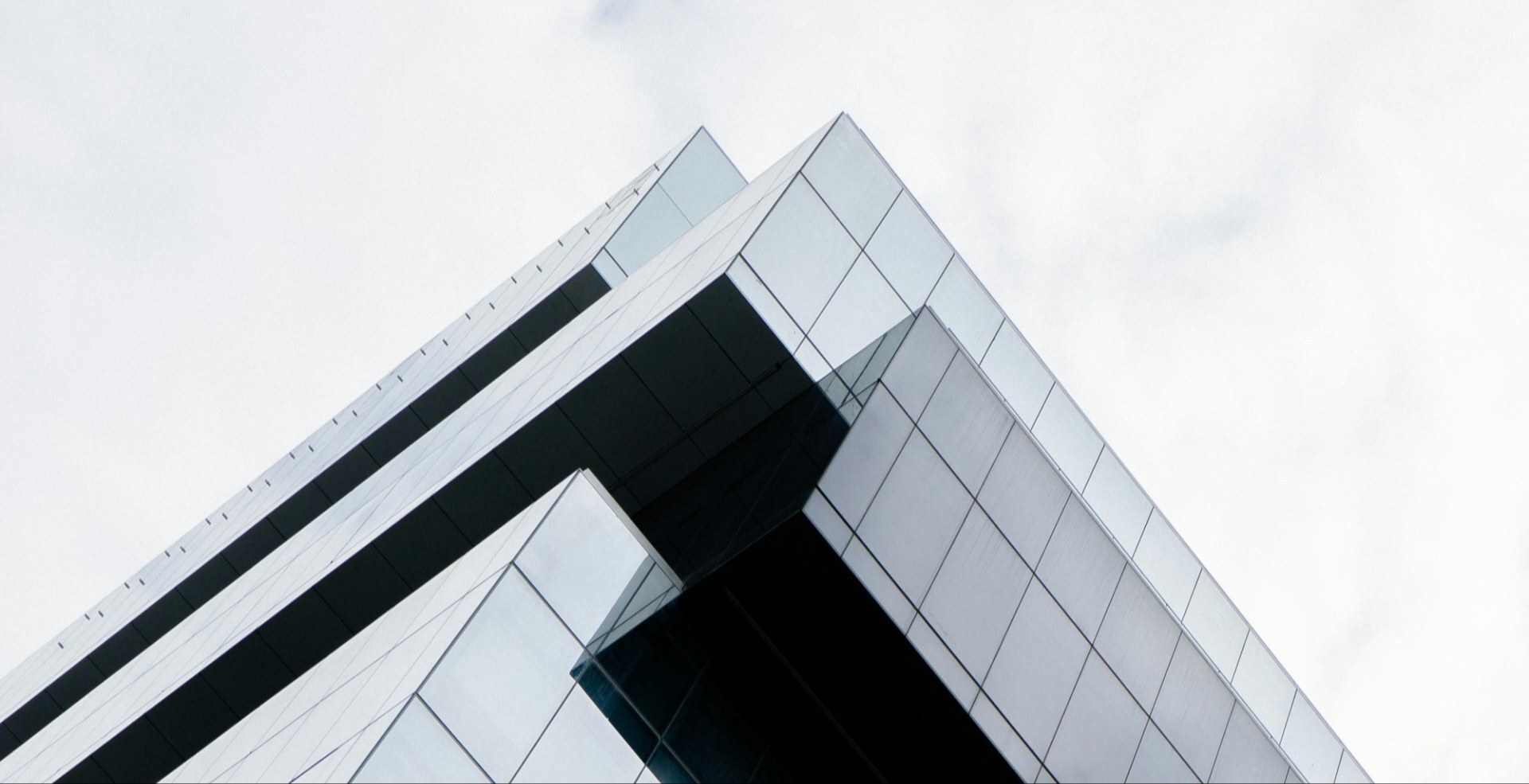 closeup of office building against grey sky