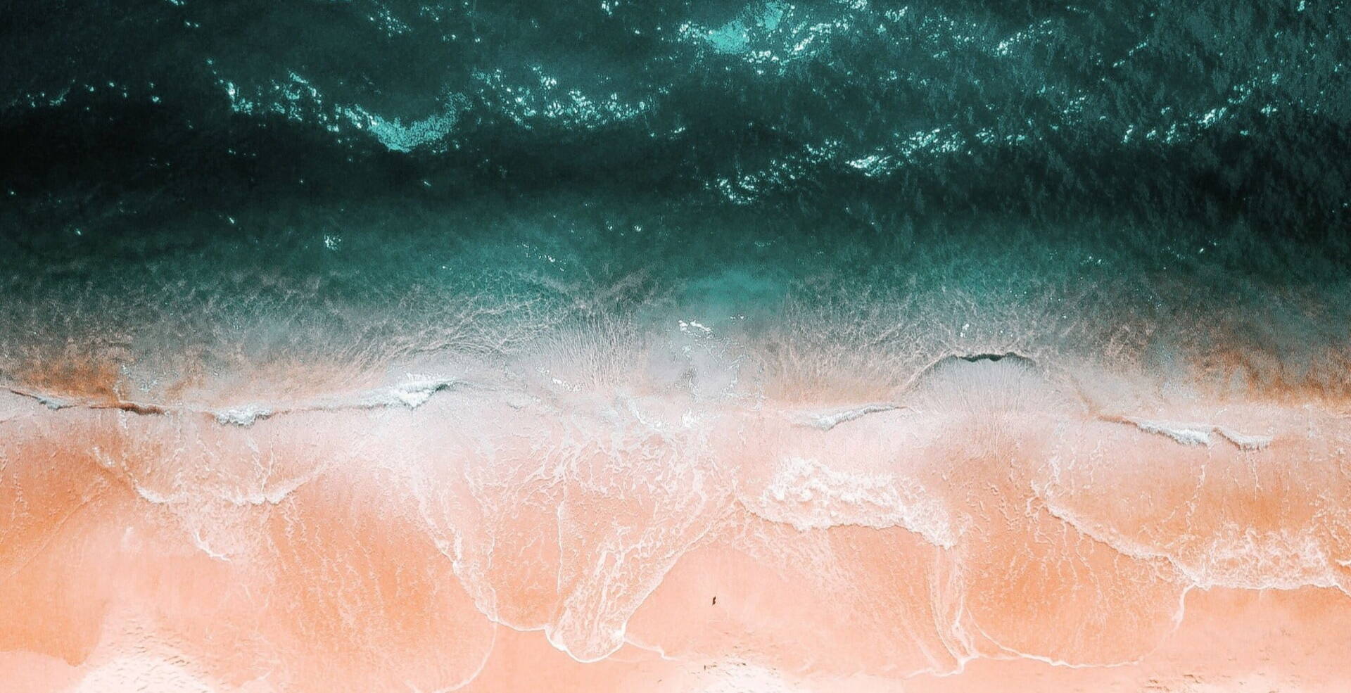 bird view of pastel waves over sand beach