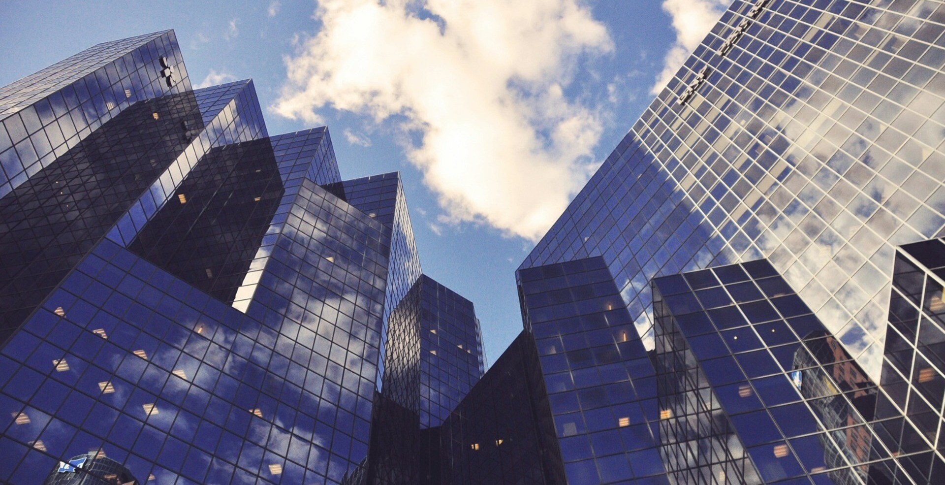 worm's view of office buildings against blue sky