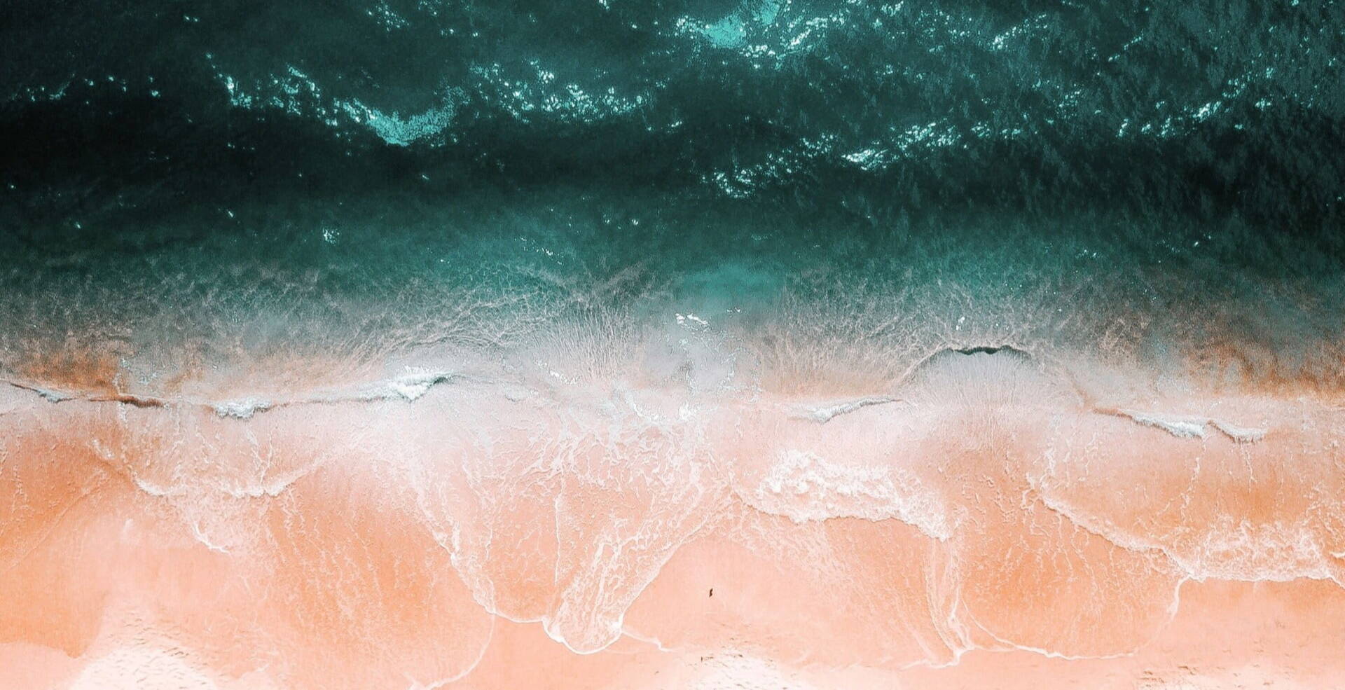 bird view of pastel waves over sand beach