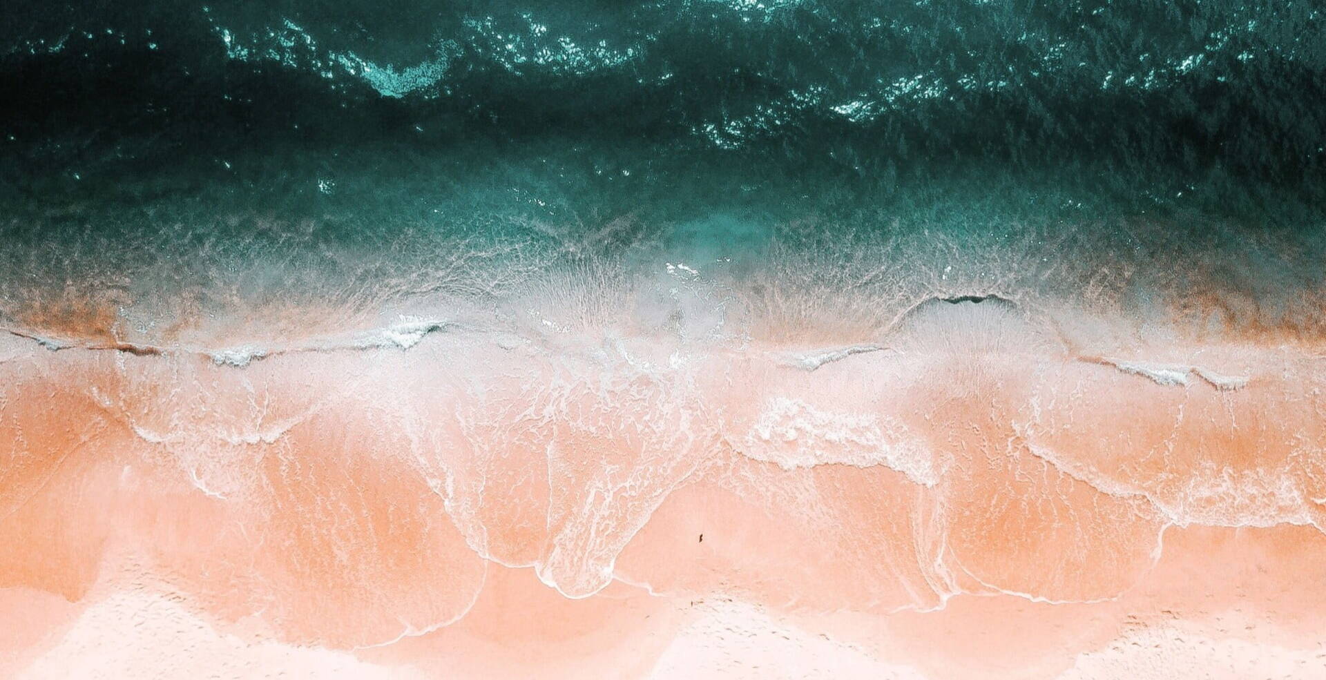 bird view of pastel waves over sand beach