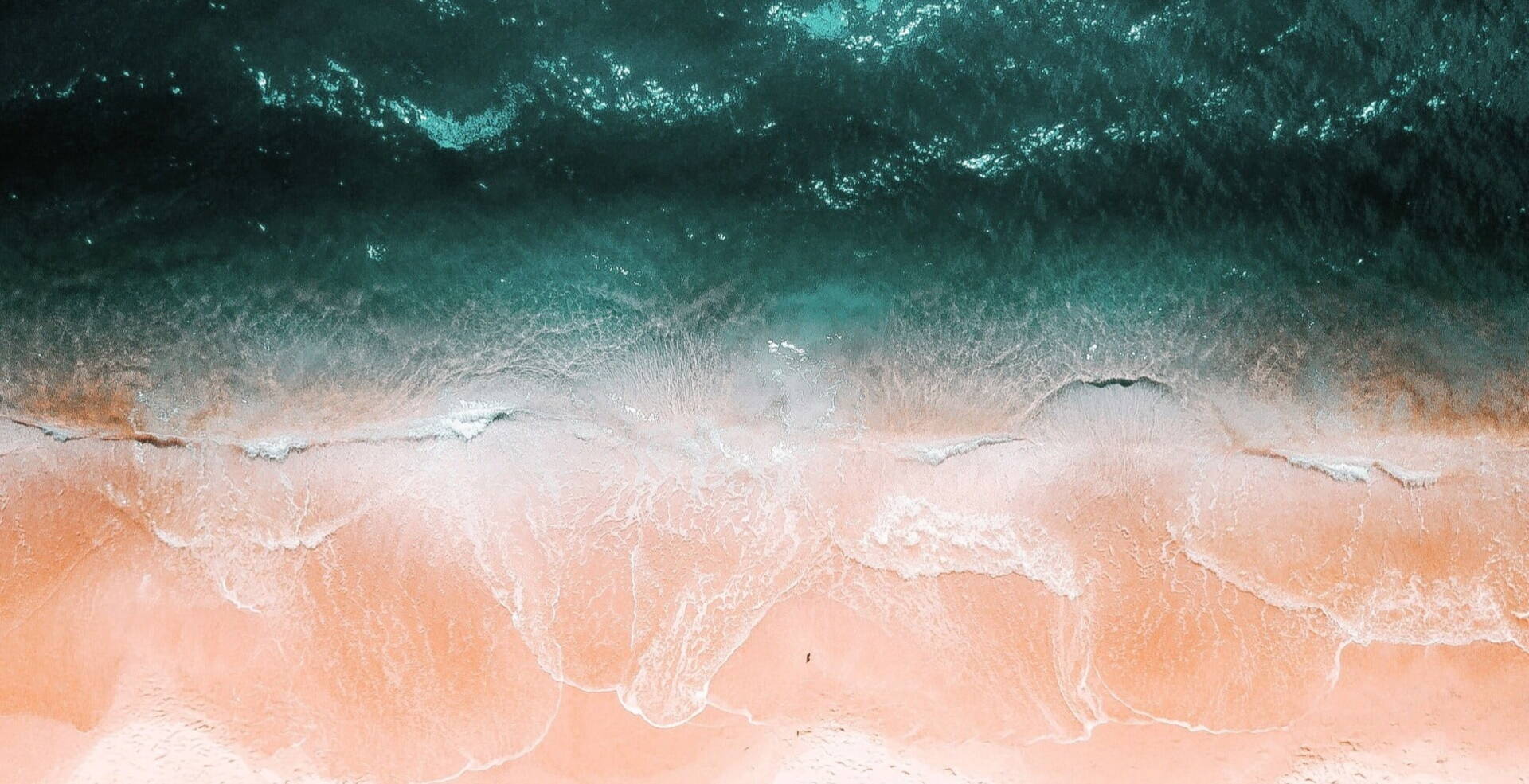 bird view of pastel waves over sand beach